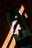 Senior woman practicing stretching and meditation on the floor, focusing on proper alignment and relaxation. photo