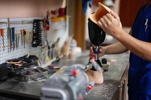 Technician assembling prosthetic leg in a workshop setting photo