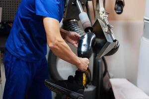 Technician polishing prosthetic leg in workshop setting photo