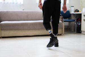 Man with prosthetic legs walking indoors in a modern setting photo