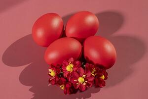 Colorful eggs, symbolizing Easter, on a colorful background and flowers photo