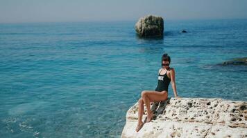 A Serene Beach Scene Featuring a Model Posing Elegantly Against the Turquoise Waters video