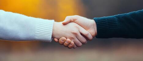 A warm handshake symbolizes connection and understanding between two individuals. photo