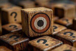 A wooden block with target design stands out among other blocks featuring question marks, creating sense of curiosity and intrigue. photo