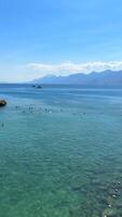 Clear turquoise water on the Mediterranean coast, with mountains in background video