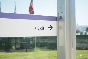 Signage Clearly Indicating the Exit Direction at a Specific Urban Location for Navigation and Safety photo