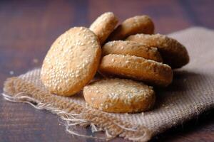 Indulge in Freshly Baked Sesame Cookies Laid Out on a Rustic Background for Your Enjoyment photo