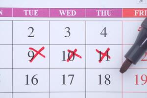 Marked Calendar Dates Displayed with Red Crosses for Enhanced Planning and Scheduling photo