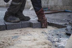 Laying Paving Stones on a Construction Site for a driveway or footpath requires skill and precision photo
