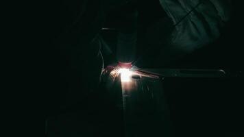 Welding process in a dark industrial workshop. A close-up shot of a welding process in a dark industrial workshop. video