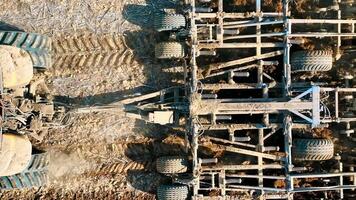 Aerial top view A tractor plows a field with a plow close up. Preparation of the field for wintering video