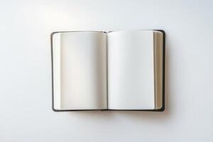 An open blank notebook lying flat, ready for writing, with clean white pages and a minimalist background photo