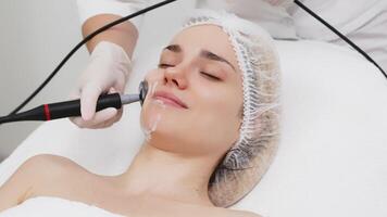 A cosmetologist performs RF lifting for facial rejuvenation and tightening. This non-invasive procedure effectively firms and smooths skin, enhancing your beauty routine video