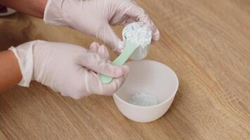 Close-up of a cosmetologist preparing an alginate face mask. This premium treatment is perfect for showcasing effective skin hydration and rejuvenation in your advertising video