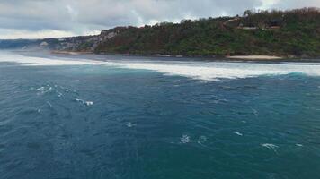 Aerial view of Bali coastline with ocean and waves on Green bowl beach on morning video