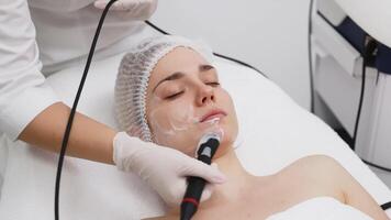 A cosmetologist performs RF lifting for facial rejuvenation and tightening. This non-invasive procedure effectively firms and smooths skin, enhancing your beauty routine video
