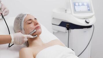 A cosmetologist performs RF lifting for facial rejuvenation and tightening. This non-invasive procedure effectively firms and smooths skin, enhancing your beauty routine video