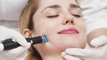A cosmetologist performs hydropeeling, deeply cleansing and rejuvenating the client's skin in a modern clinic. Perfect for showcasing advanced beauty treatments and glowing skin results video
