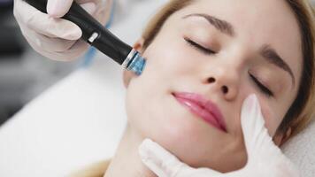 A professional performs a hydropeeling facial treatment on a woman in a modern clinic, focusing on deep skin cleansing and rejuvenation. Perfect for showcasing advanced skincare techniques video