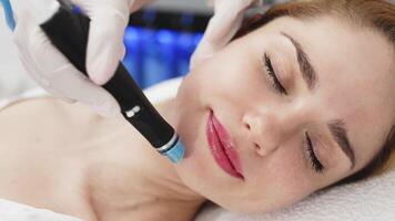 A professional performs a hydropeeling facial treatment on a woman in a modern clinic, focusing on deep skin cleansing and rejuvenation. Perfect for showcasing advanced skincare techniques video