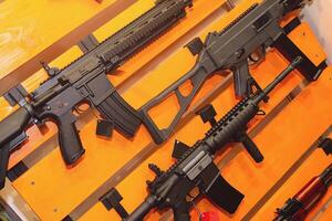 Automatic rifle hanging on the stand in the store photo