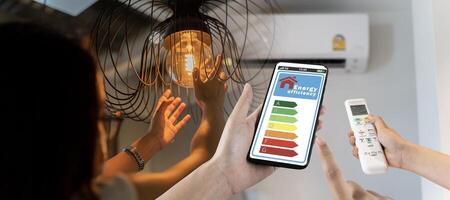 Home appliance energy efficient. Household equipment and energy class chart. Power saving concept. Woman change a new electric bulb, open air conditioning 25 degrees photo