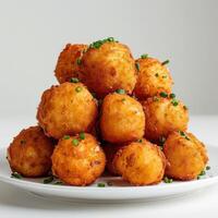 a plate of tater tots with chives on it photo
