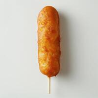 a large piece of food on a stick on a white surfac photo