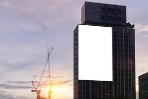 Mock up white background billboard on building, clipping path for Mockup. A large empty billboard on a city background photo
