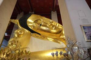 Face of Phra Non Chakkrasi at Wat Phra Non Chakkrasi Worawihan is gold reclining buddha big statue. photo