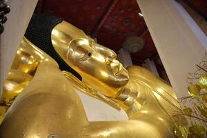 Phra Non Chakkrasi at Wat Phra Non Chakkrasi Worawihan is big gold reclining buddha statue. photo
