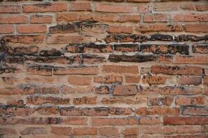 Antique wall of red old bricks in a row. Vintage bricks background. photo