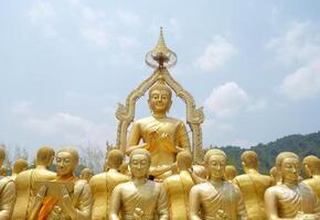 Buddha statue disciples sitting on the line in front of Buddha. photo