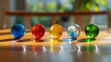 Five multi-colored balls lie in a row on the table photo