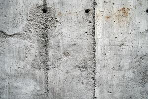 Weathered Concrete Wall with Vertical Lines and Patches photo