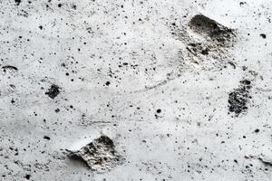 Close-up of a White Concrete Wall with Irregular Holes photo