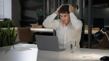 Shocked Caucasian businessman with laptop failure in office business man shock problem fail lose online trouble company crisis male professional computer stress worker bankrupt browsing pc crash error photo