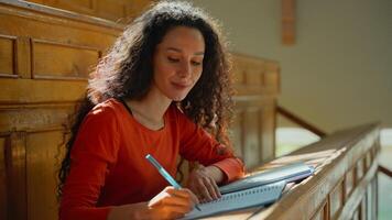 Happy smiling woman girl student listen teacher class lecture noting information female study at table writing studying learning write learn course in college academy university auditorium education photo