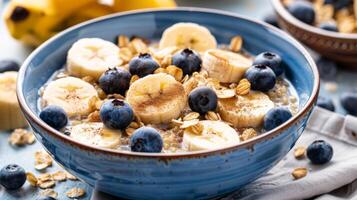 Healthy Quinoa Cereal Bowl with Almond Milk Sliced Bananas and Granola photo