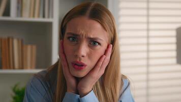 Close up shocked female face Portrait amazed scared afraid astonish Caucasian woman open mouth holding head with shock bad news unexpected business trouble failure problem girl businesswoman in office photo