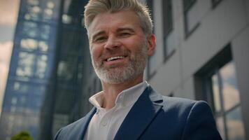 Middle-aged man senior mature business employer businessman browsing mobile phone chatting app smartphone check email network media scrolling cellphone in city near office building smiling at camera photo