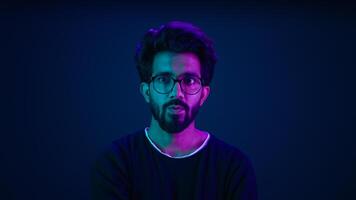 Male portrait neon background shocked amazed astonish wonder Indian man coder hacker computer technology worker guy looking in front futuristic high-tech software hologram mock up infographic backdrop photo