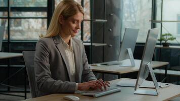 Caucasian 40s woman typing computer online job in office smile enjoy telework internet company working. Businesswoman manager worker using corporate web service executive female chatting with clients photo