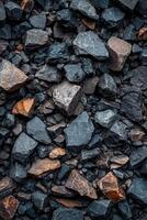 Background of dark and rusty sharp edged rocks forming a rough textured surface photo