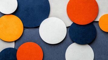 Geometric paper cut out shapes in navy blue orange and white against a textured grey background photo
