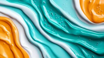 Macro image of liquid paint waves mixing turquoise and orange with marbled patterns photo