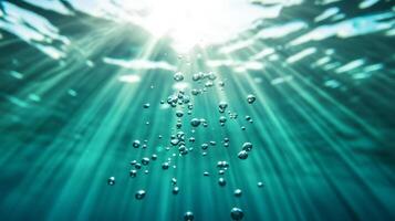 Magnified view of underwater bubbles rising towards the surface with light rays penetrating photo