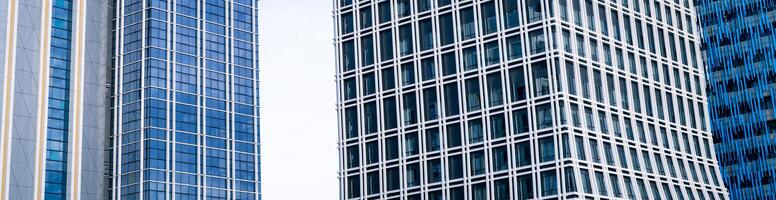 Skyscraper glass building of corporate headquarters in the downtown business area. Towering facade and windows embodying sleek, modern office environment. Financial institution. Modern architecture. photo