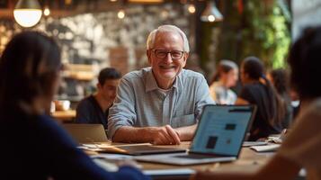 Senior man working as a mentor in a startup incubator, surrounded by his entrepreneurs, confident and wise photo