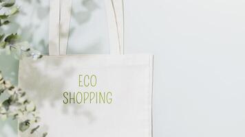 Shopping bag with text Eco shopping on blue background with copy space photo